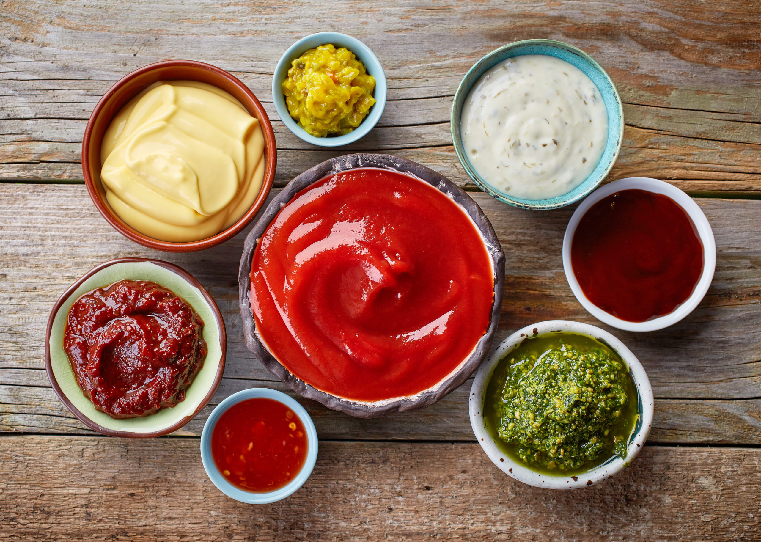 birds eye view of an assortment of bbq sauces in ramekins